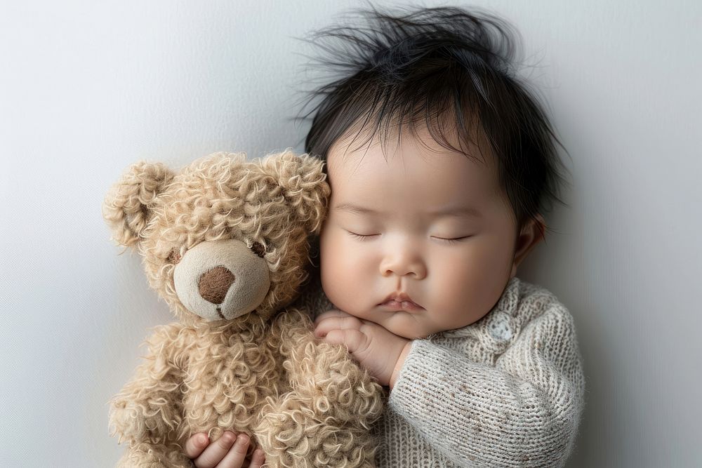 Asianbaby newborn sleep and cuddle teddy bear photography portrait sleeping.