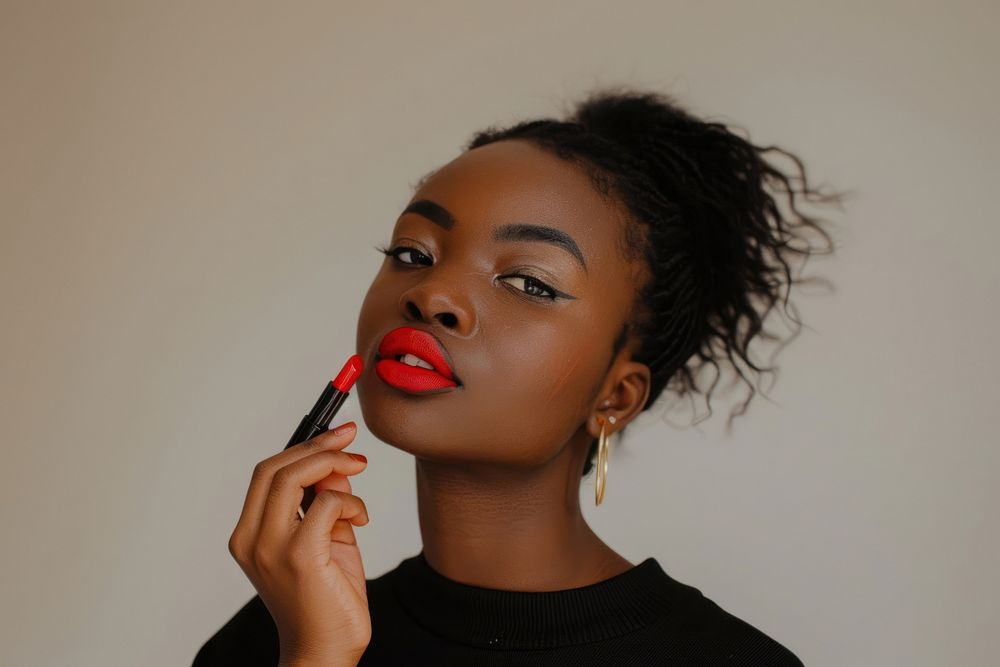 Black holding red lipstick with confident pose cosmetics person female.