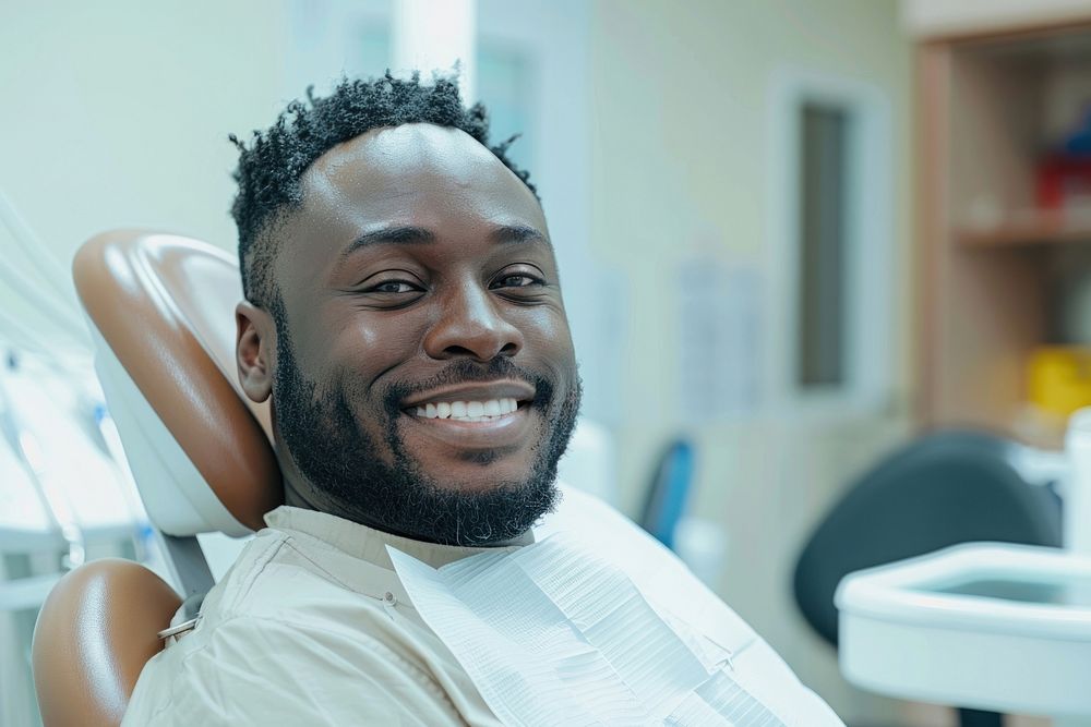 Black man smile sitting on dentist chair dimples person human.