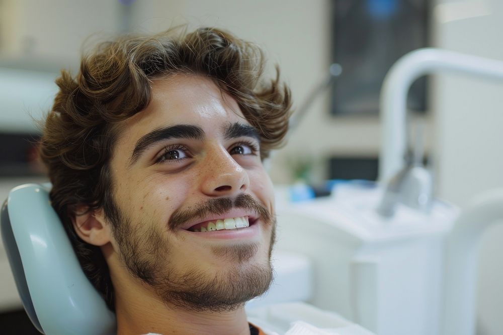 Man smile with braces sitting on dentist chair dimples person human.