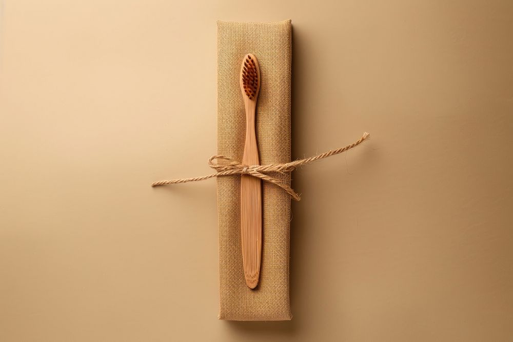 Wooden toothbrush with craft plain package box with fabric label mockup weaponry device blade.