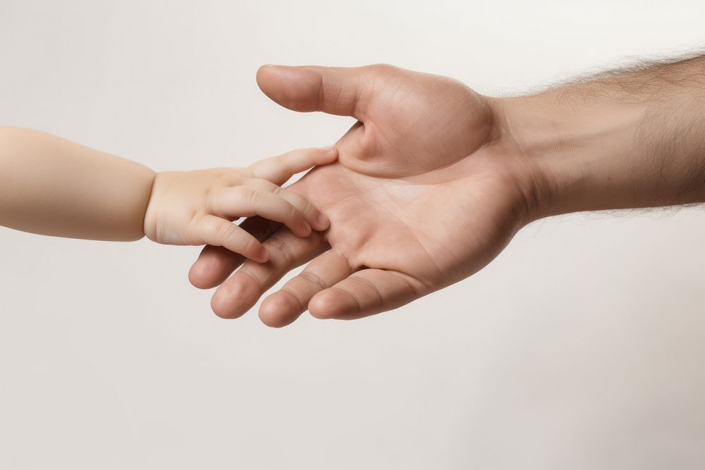Hand of an adult man and child holding each other hand massage person.