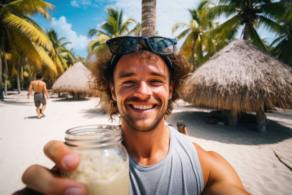 Adult man happieness with drinking coconut water outdoors selfie accessories.