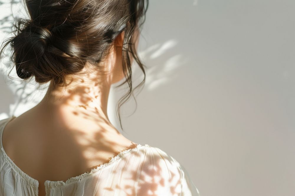 Flower shadow casting on woman back shoulder person female.