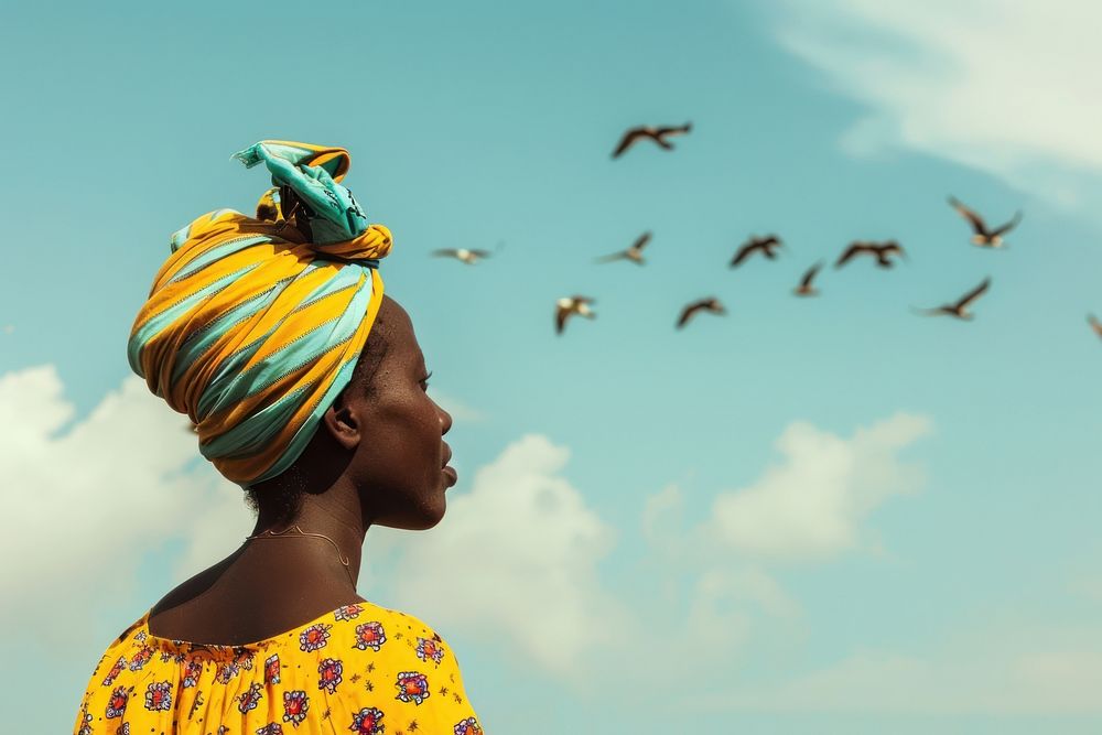 Refugee african woman look at birds flying away shoulder clothing apparel.