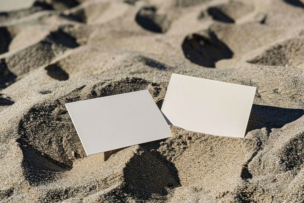 Business cards mockup paper sand outdoors.