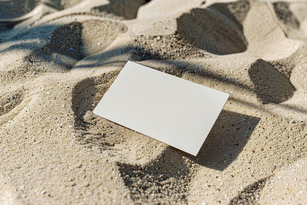 A business card mockup paper sand outdoors.