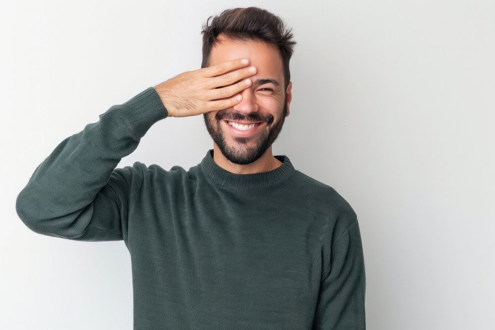 Man covering one eye with hand smile face person.