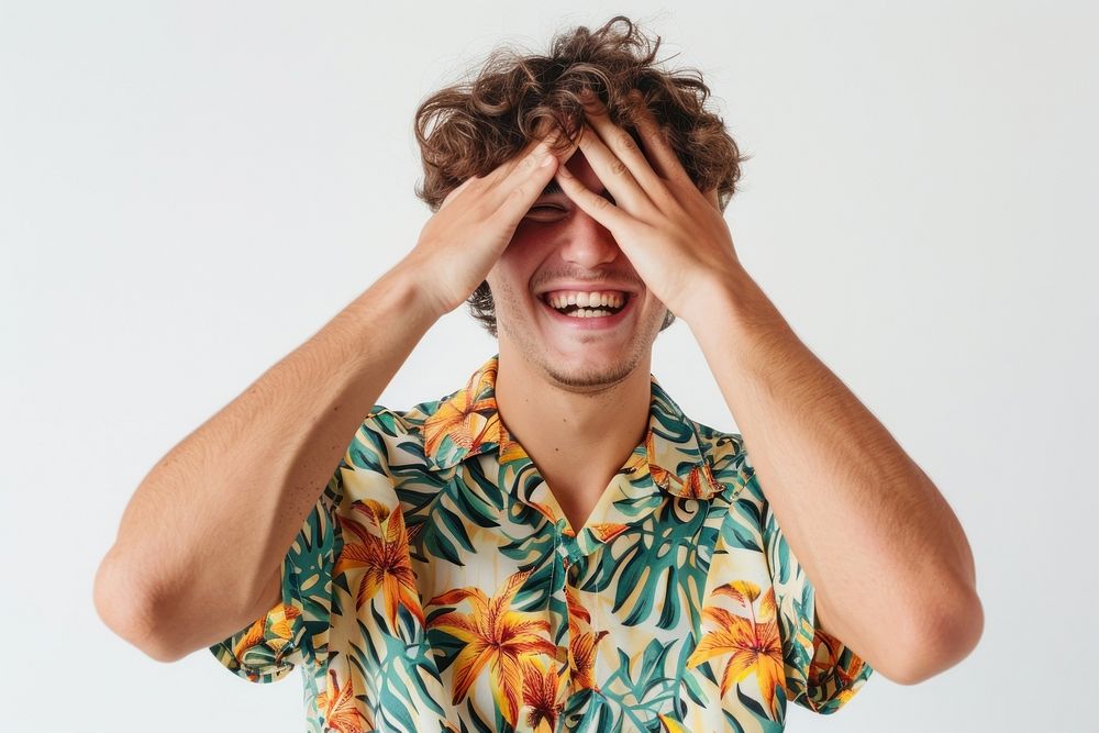 Young male covering eyes with hands smiling cheerful and funny laughing clothing apparel.