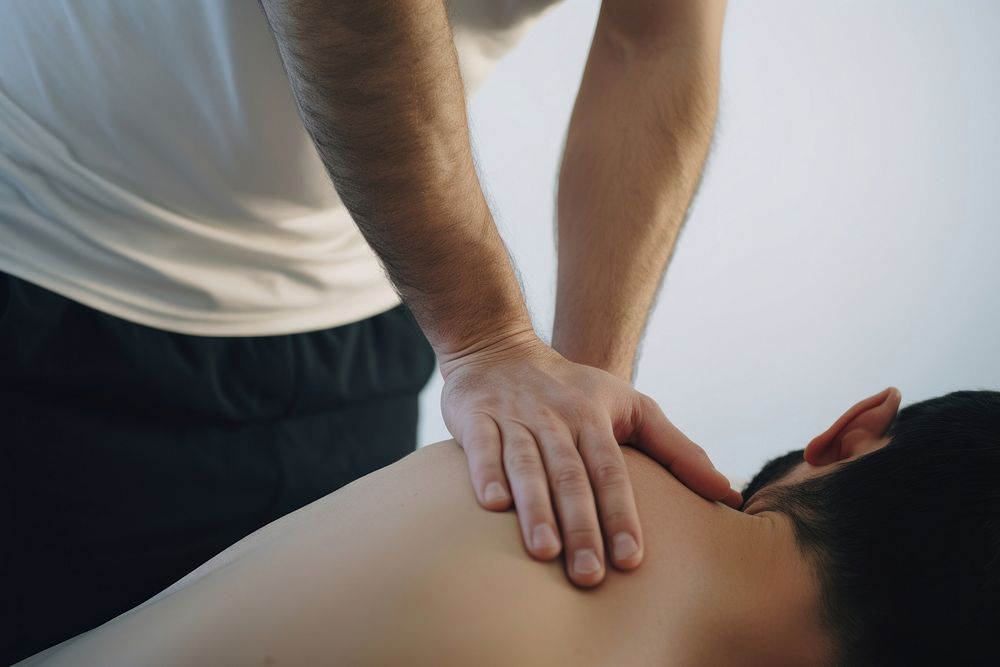 Physiotherapist helping patient therapy massage person.