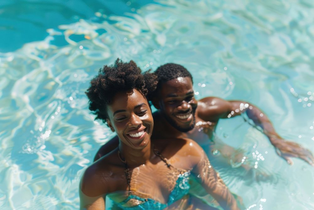 Black couple swimming in a pool photography summer accessories.
