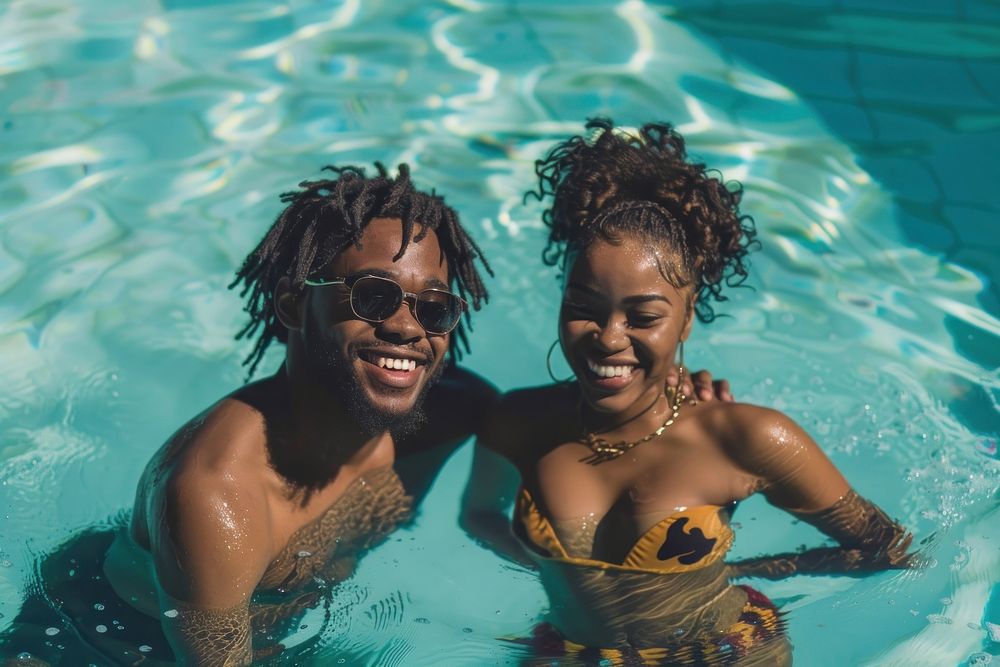 Black couple swimming in a pool accessories recreation accessory.