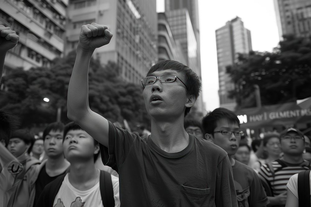 The people raised arm and raised fists photography face man.