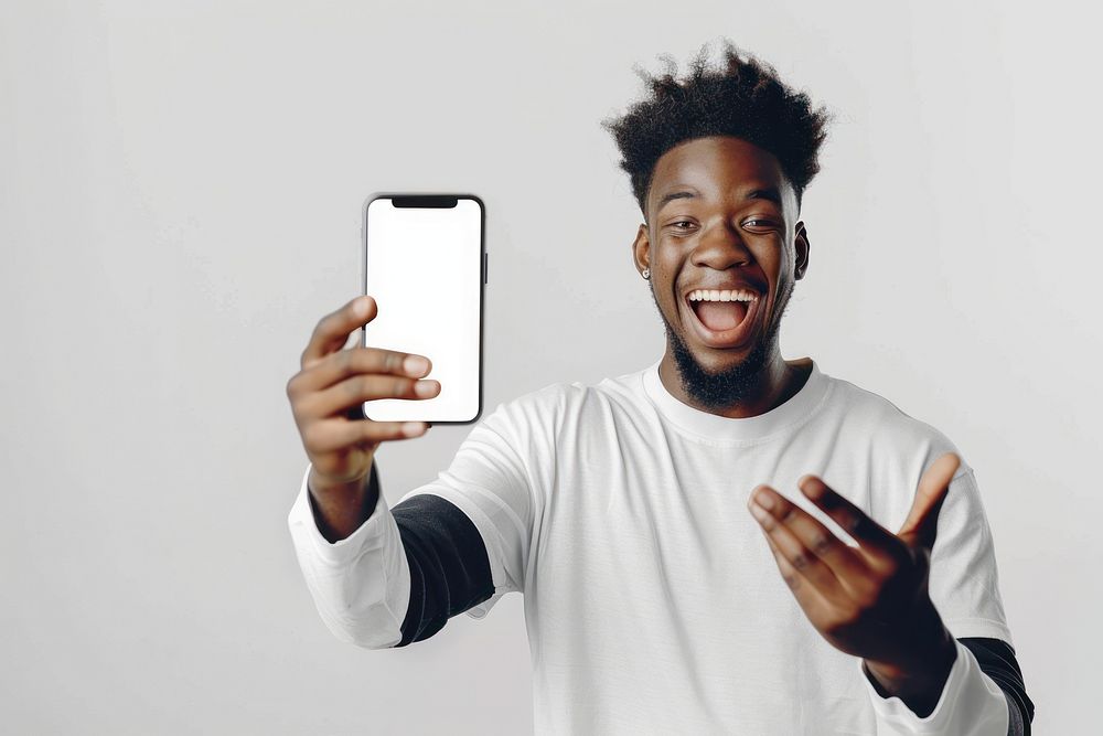 Portrait of excited black guy holding big smartphone electronics surprised person.
