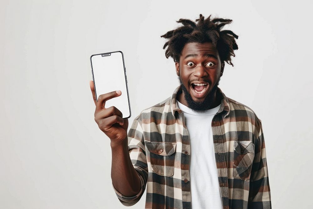 Portrait of excited black guy holding big smartphone photo photography electronics.