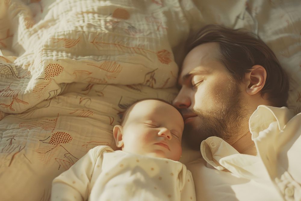 Baby sleeping with father romantic blanket person.