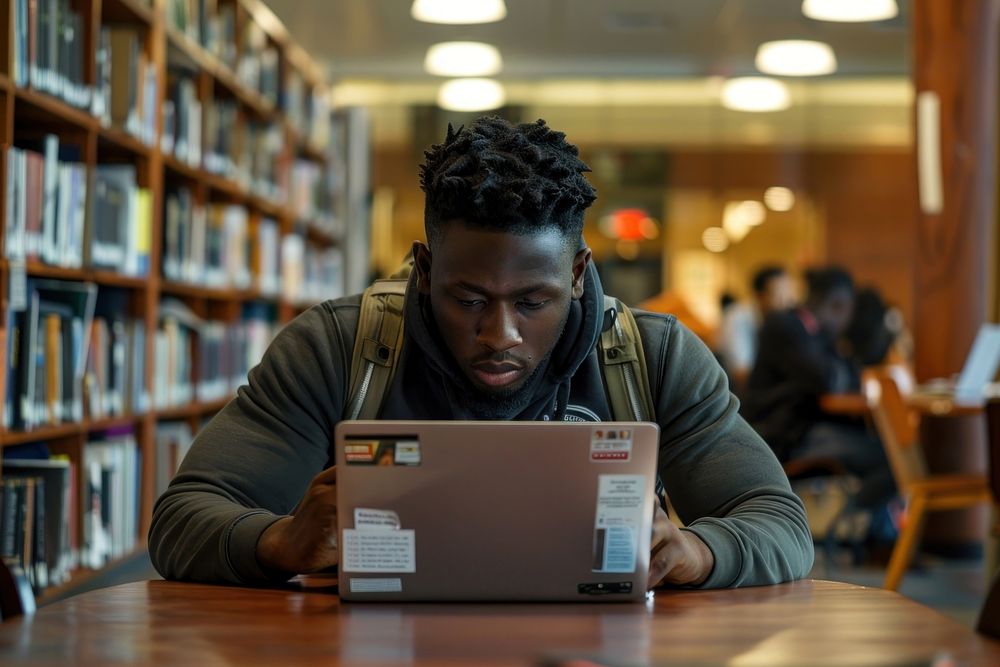 Black man student laptop publication electronics.