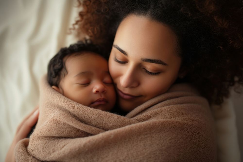 Caring biracial mother hold lean to chest cute little infant toddler blanket female person.