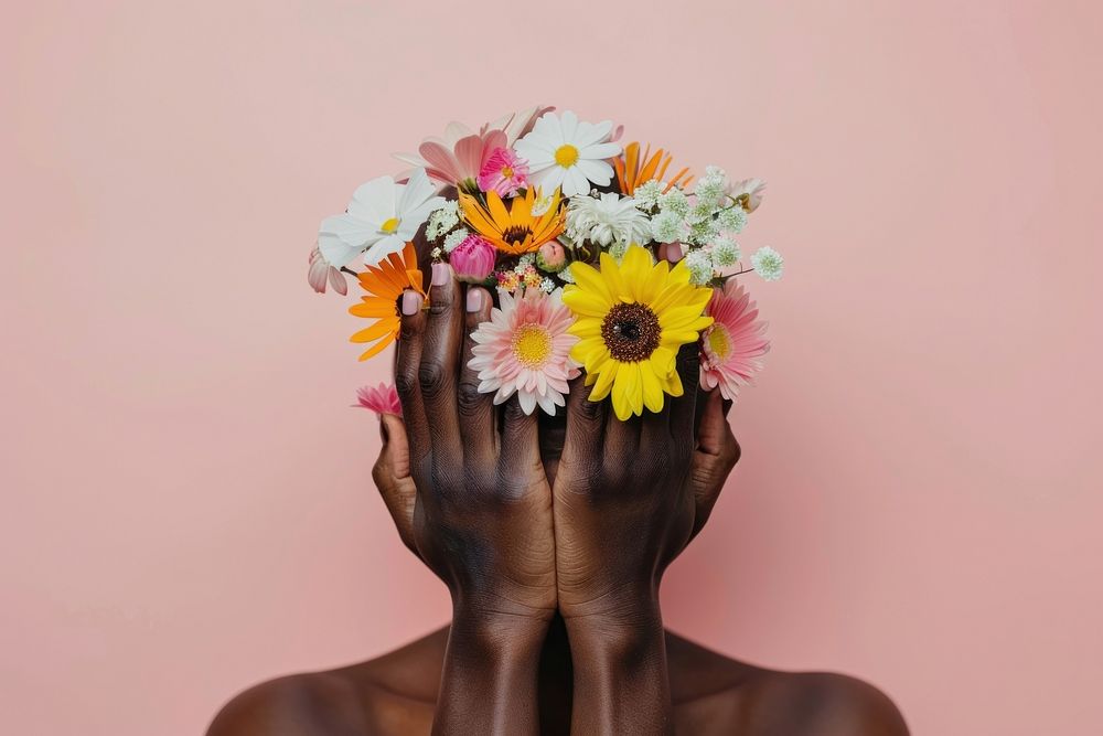 Black people Hands holding paper head with flowers hand asteraceae blossom.