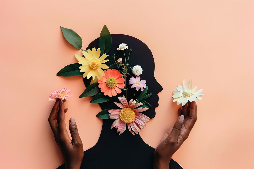 Black people Hands holding paper cut head with flowers asteraceae blossom female.
