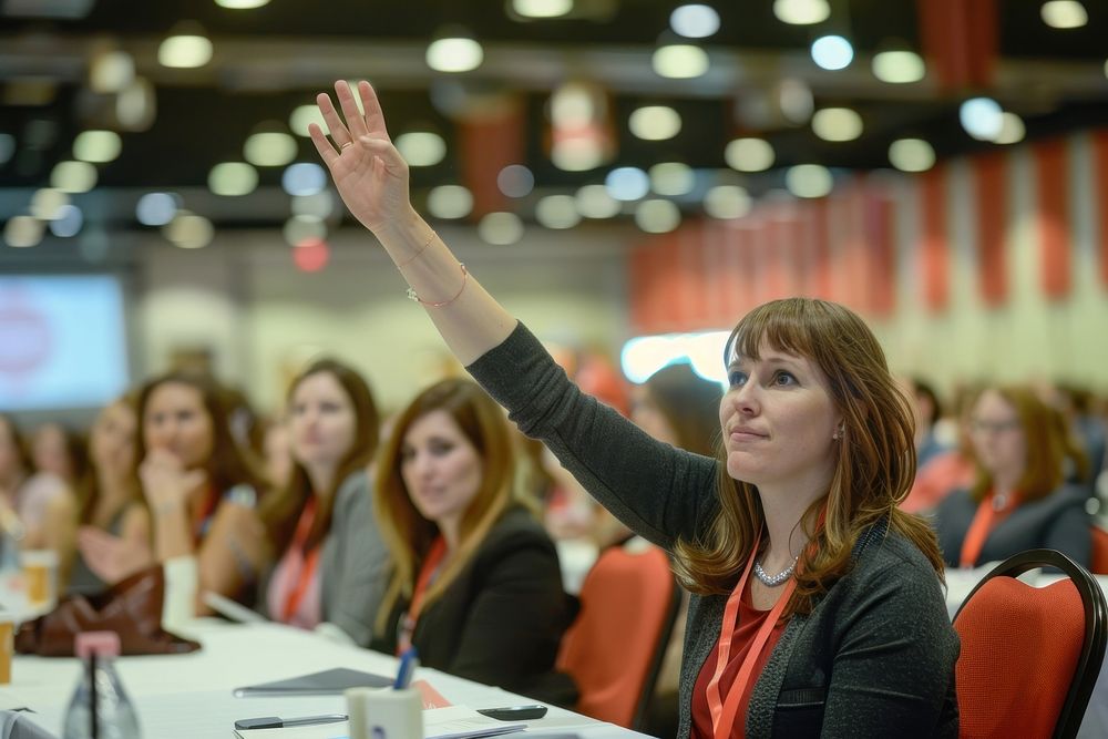Female entrepreneur raising her hand to answer female accessories electronics.