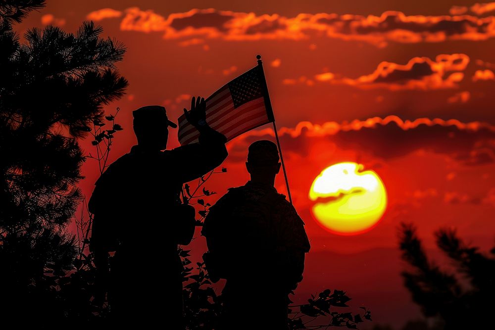 Veteran Saluting flag backlighting outdoors.