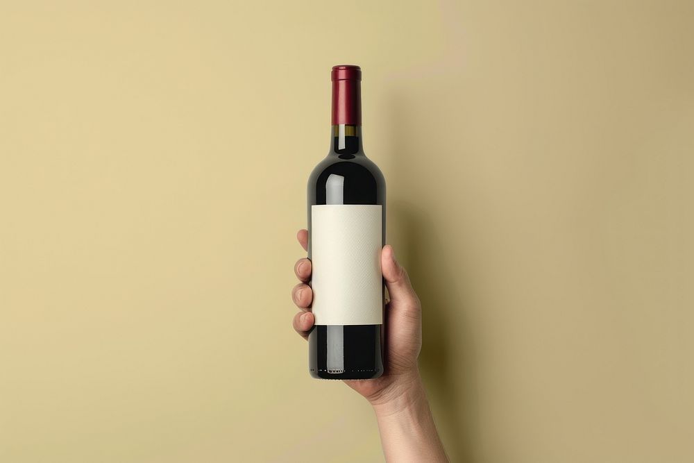 Person holding wine bottle cosmetics beverage alcohol.