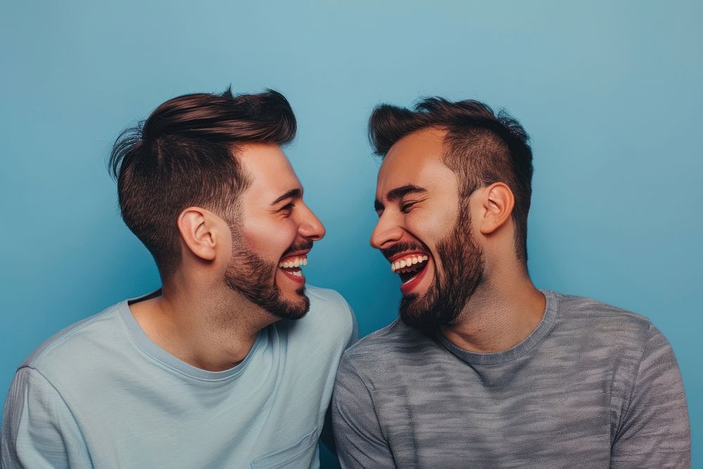 Two homosexual men laughing at each other person human happy.