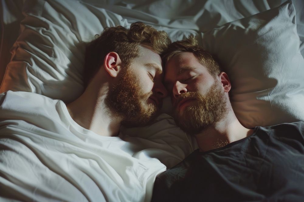 Gay male couple romantic cuddling person.