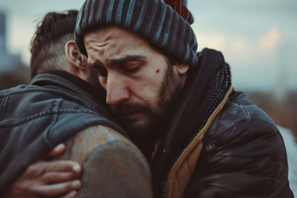 Man comforting another man clothing hugging worried.