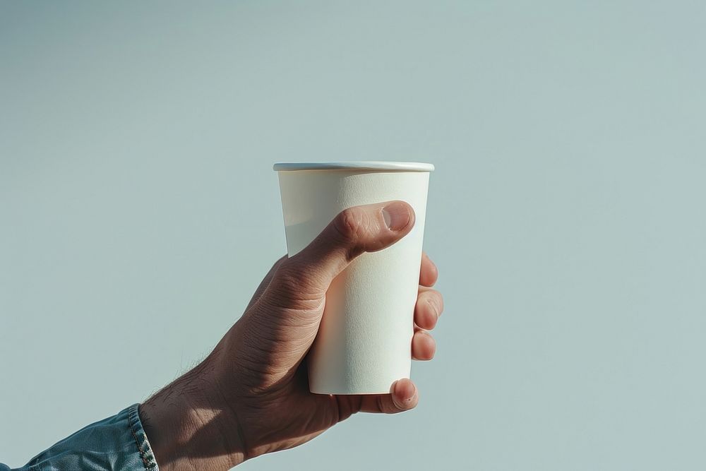 Hand hold paper cup beverage finger person.