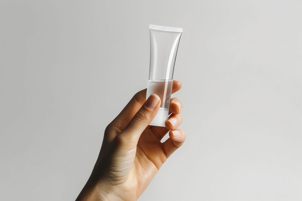 Hand hold transparent cosmetic tube glass.