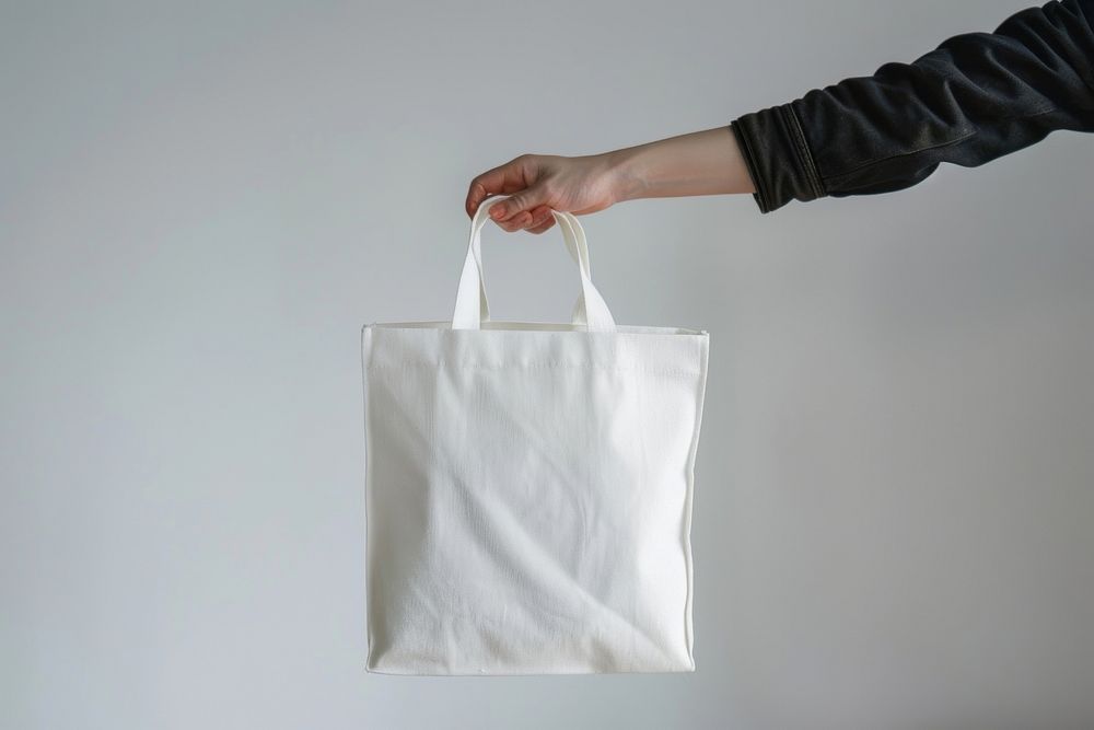 Hand hold white tote bag accessories accessory handbag.