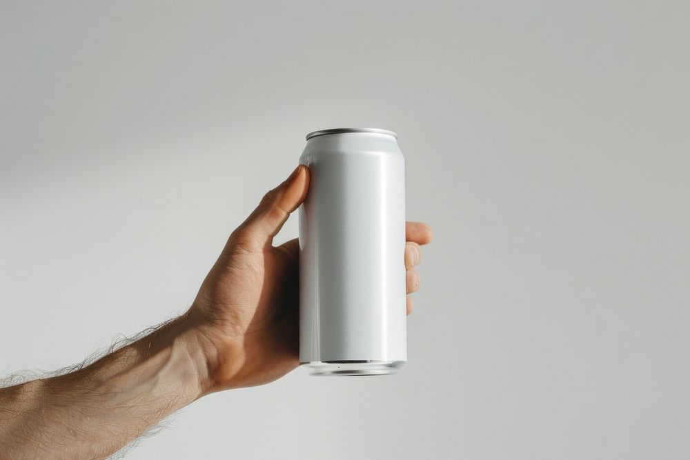 Hand hold white drink can tin.