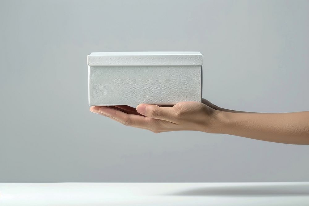 Hand hold white product box letterbox mailbox.