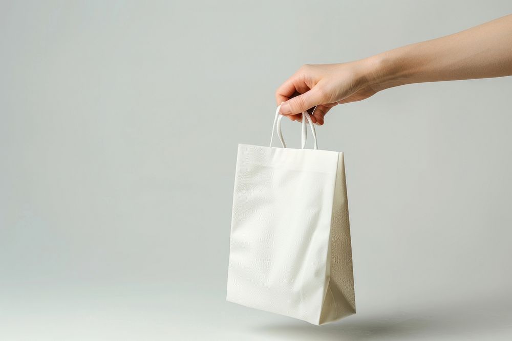 Hand hold white gift bag accessories accessory handbag.