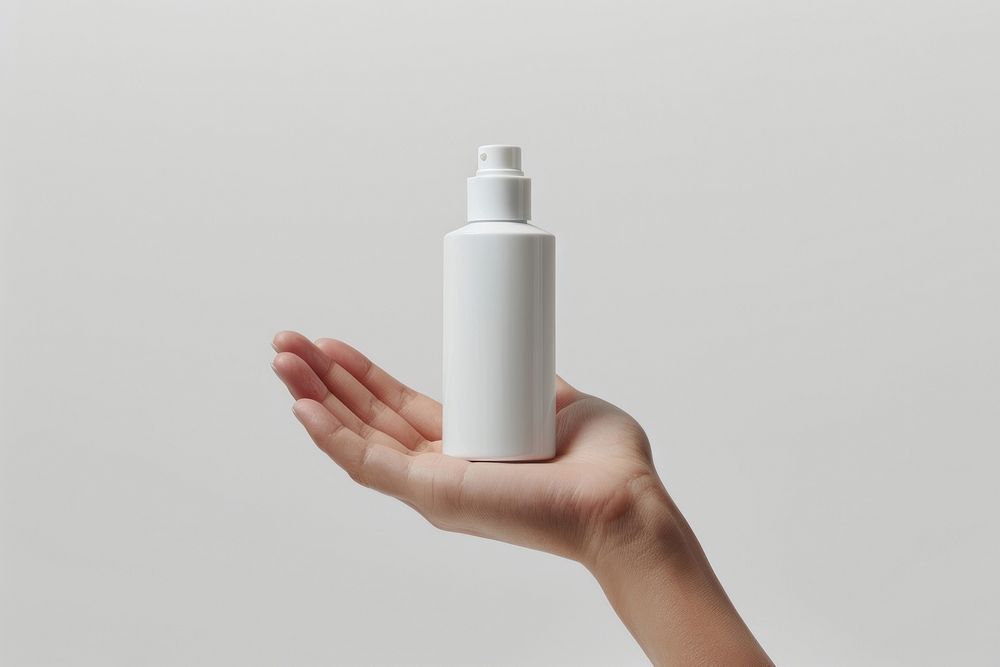 Hand hold white cosmetic bottle cosmetics cylinder lotion.