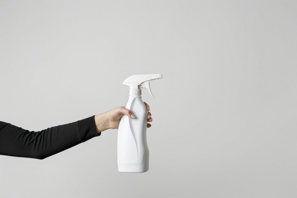 Hand hold white cleaning spray bottle appliance device person.