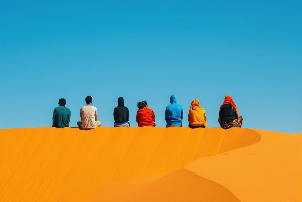 Six middle east friends sitting on top of the sand dunes sky outdoors horizon.
