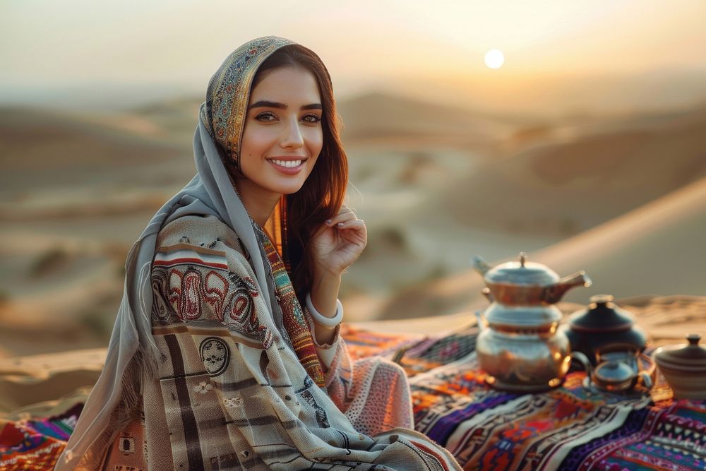 Happy Middle east woman sitting at dessert on evening cookware clothing blanket.