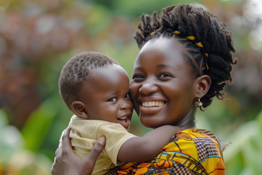 African mother smiles as she holds her child photography face portrait.