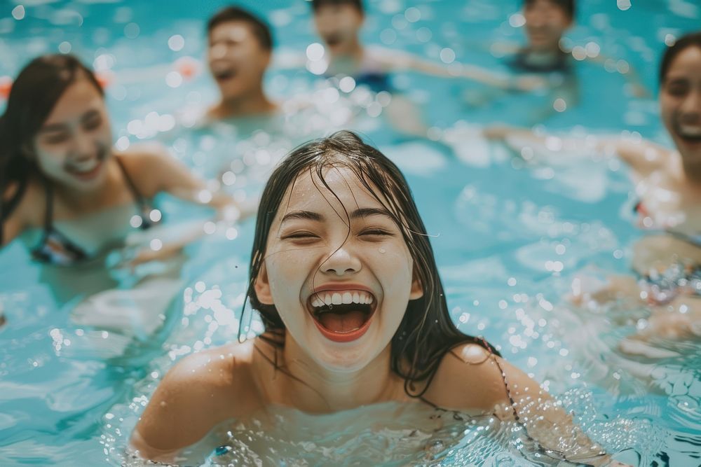 Asian woman laughing and swimming in the pool happy shouting person.