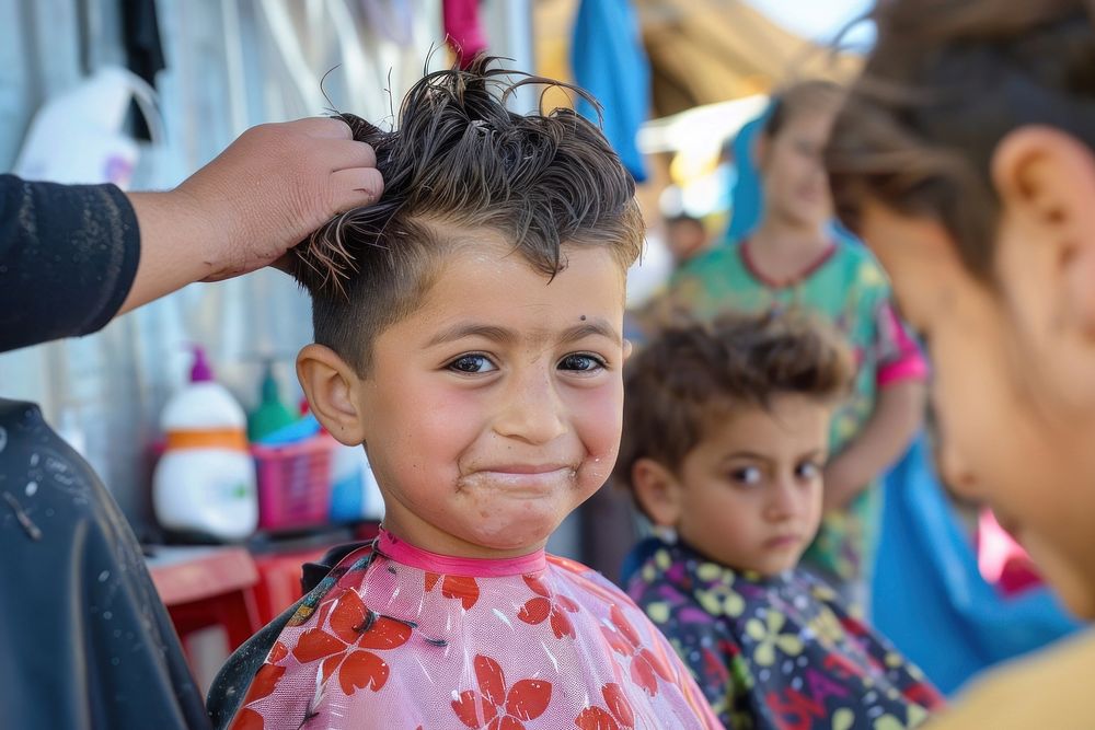 Happy refugee children have haircut hairdresser person female.