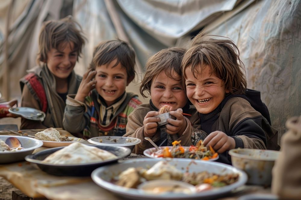 Happy refugee children having dinner together at refugee camp furniture person female.