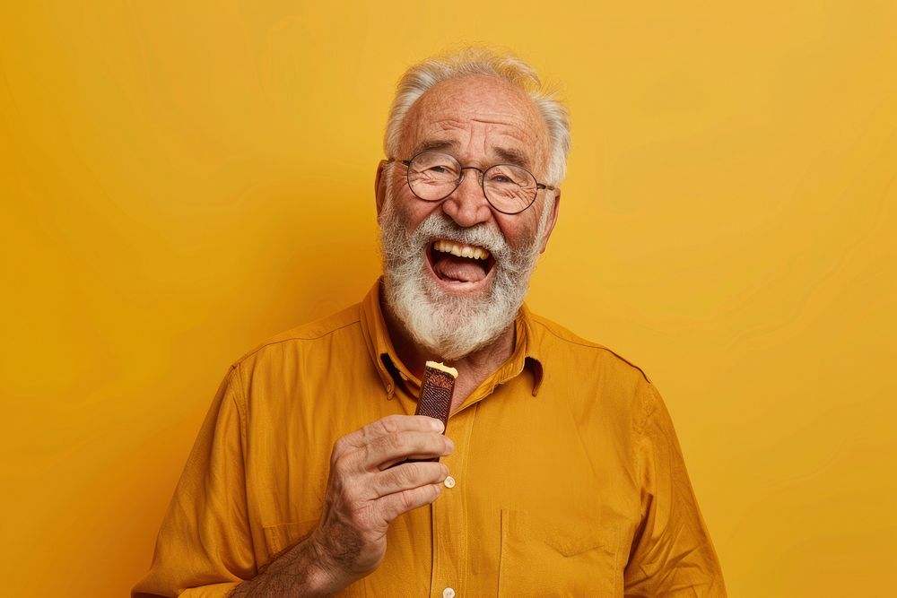 Happy senior man eating chocolate accessories accessory laughing.