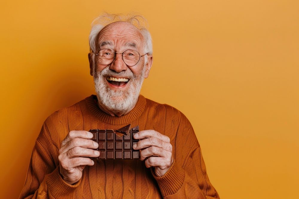 Happy senior man eating chocolate accessories accessory laughing.