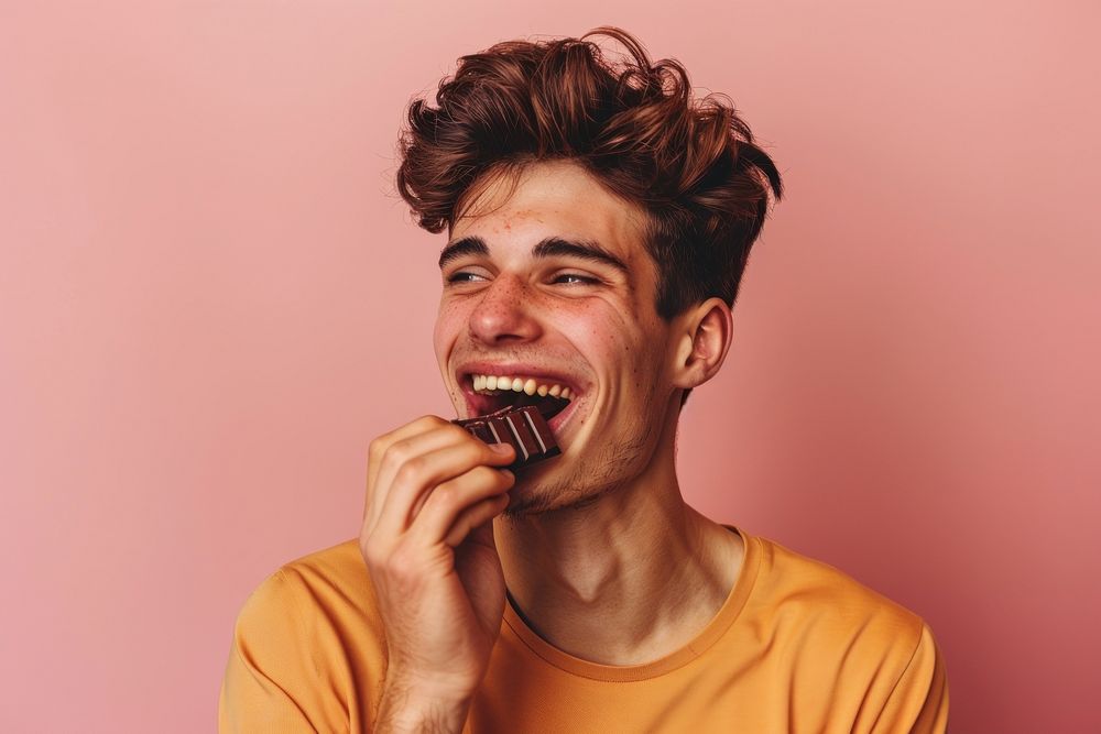 Happy young gay eating chocolate person biting human.