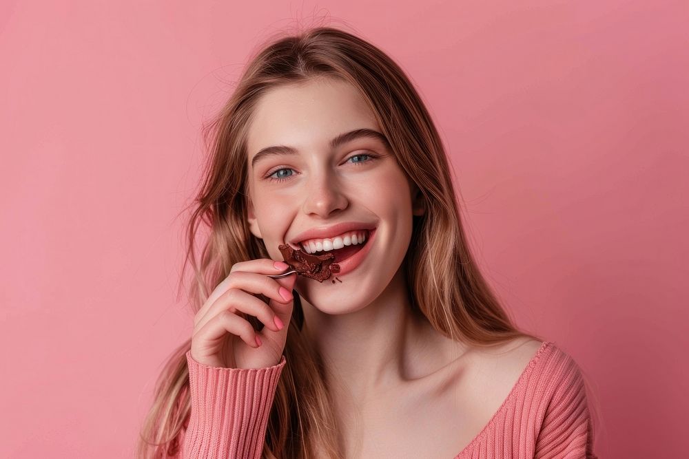 Happy young lady eating chocolate person biting female.