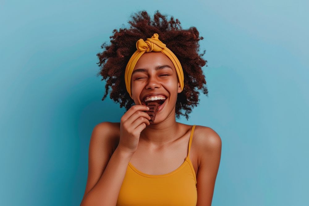 Happy young lady eating chocolate laughing person female.