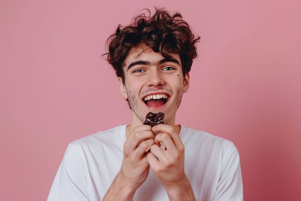 Happy young man eating chocolate person biting human.